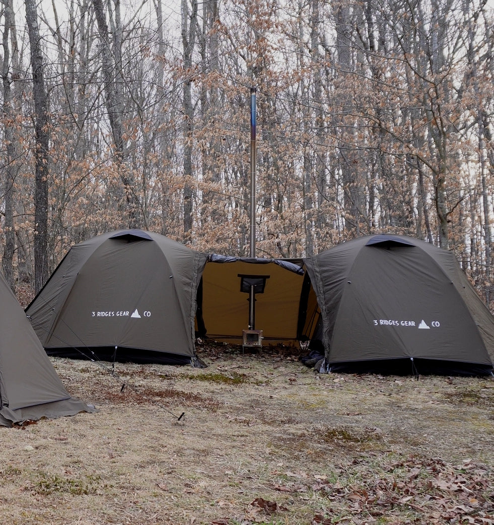Two Mau-Har Hot Tents sharing one vestibule and one stove.