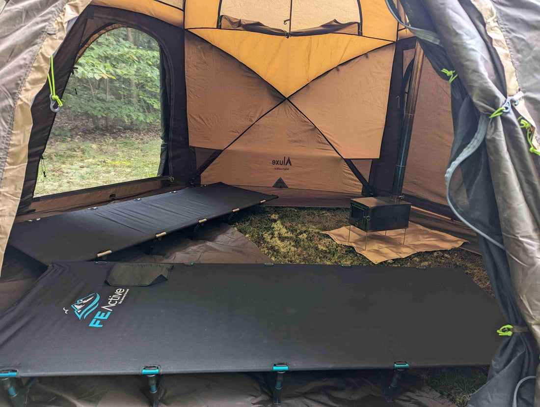 Interior of Hercules hot tent with stove and two cots.