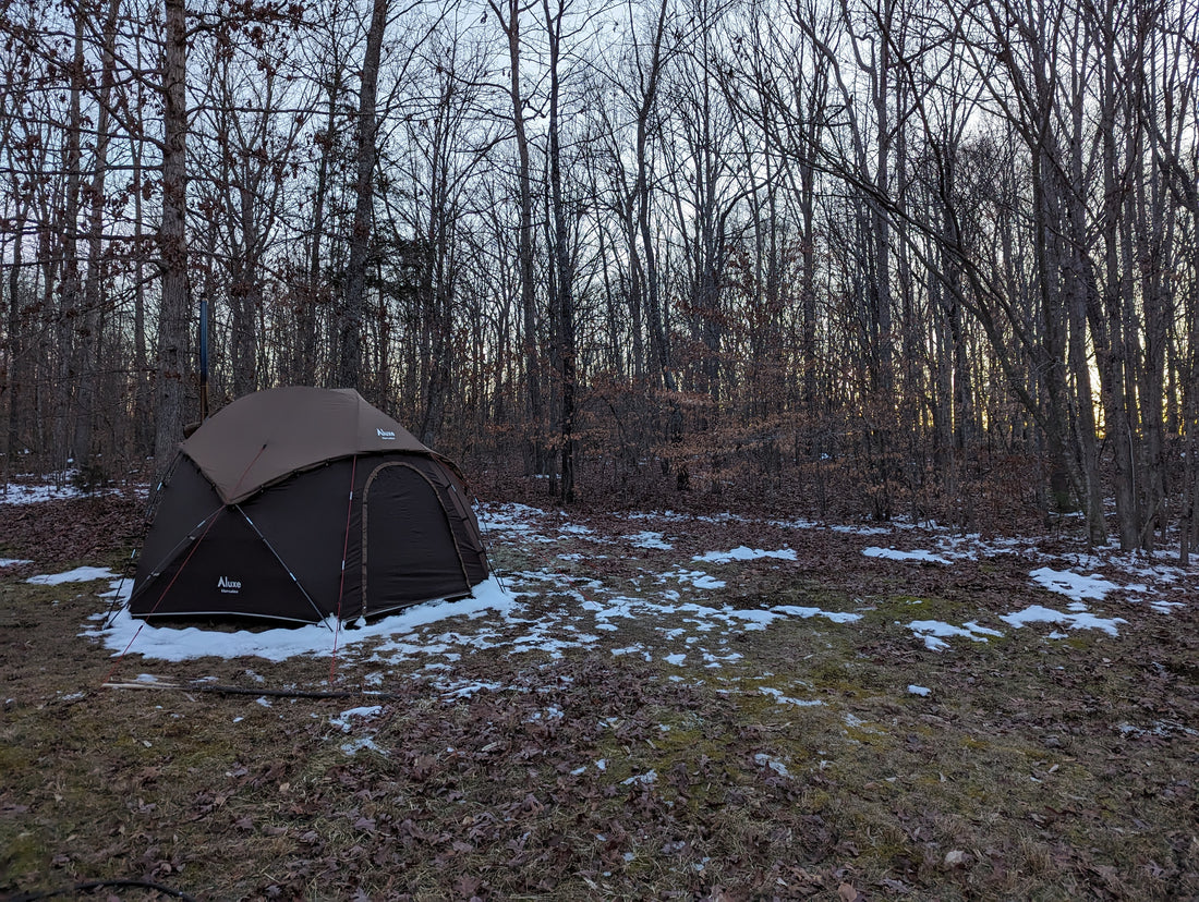 Hercules Hot tent with tent stove on a snowy winter evening camp